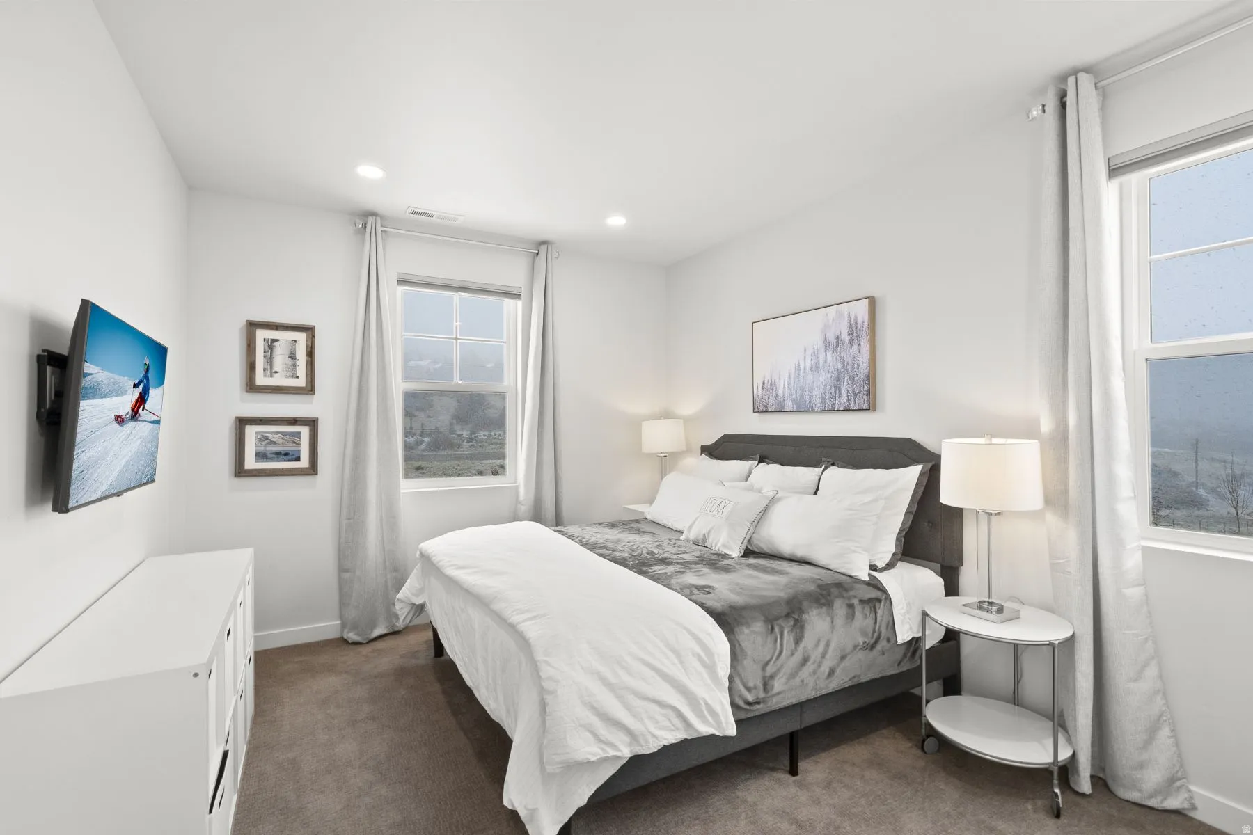 Bedroom with dark colored carpet and recessed lighting
