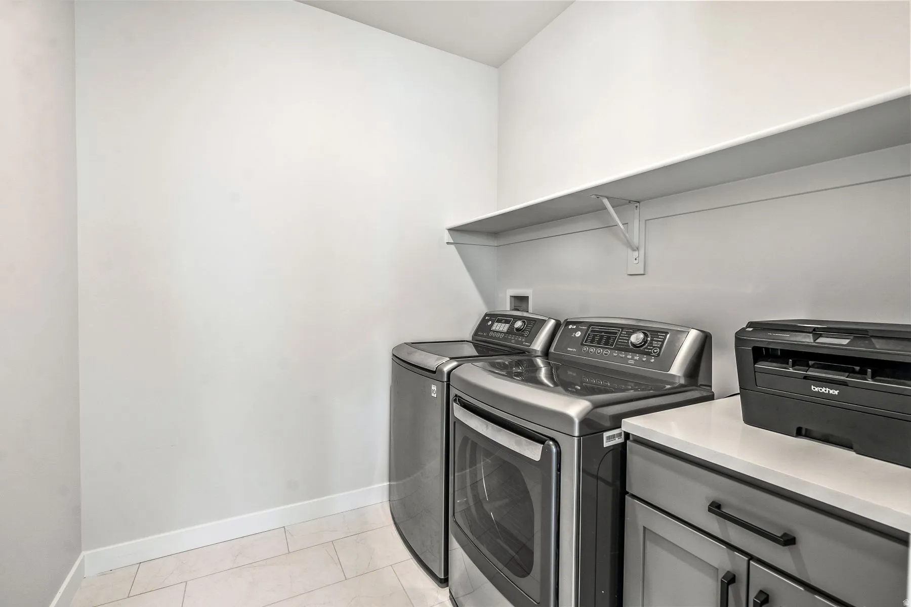 Laundry area with baseboards and washer and dryer