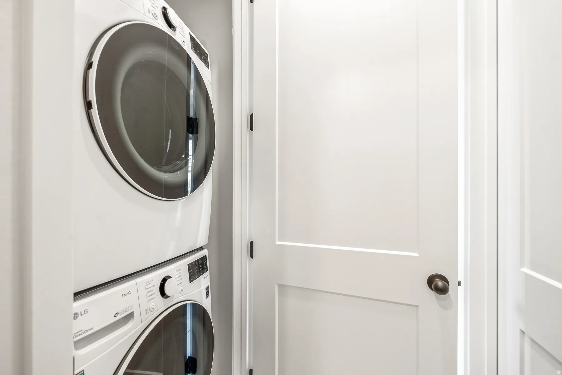 Laundry area featuring stacked washer / drying machine