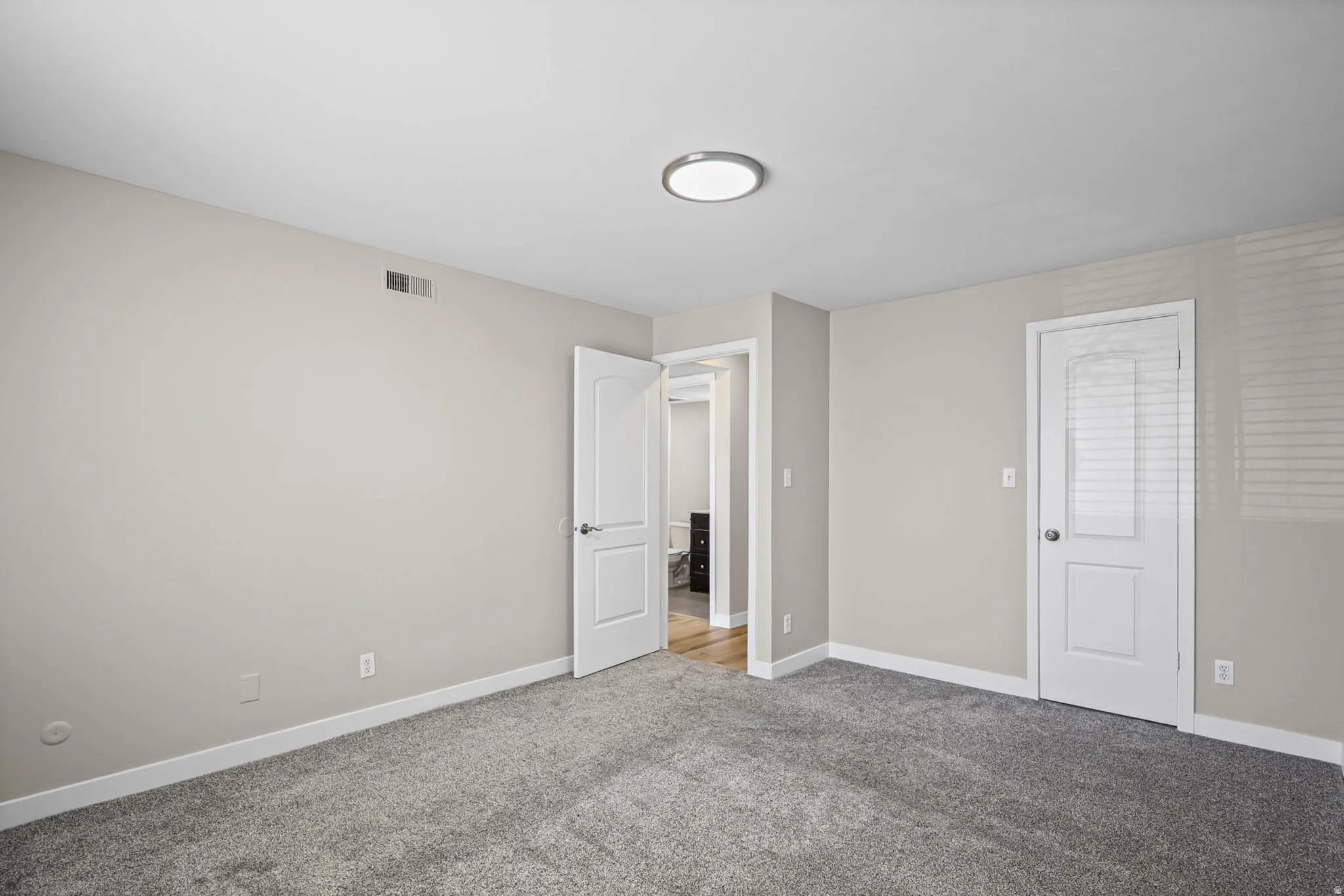 Unfurnished bedroom featuring carpet and baseboards