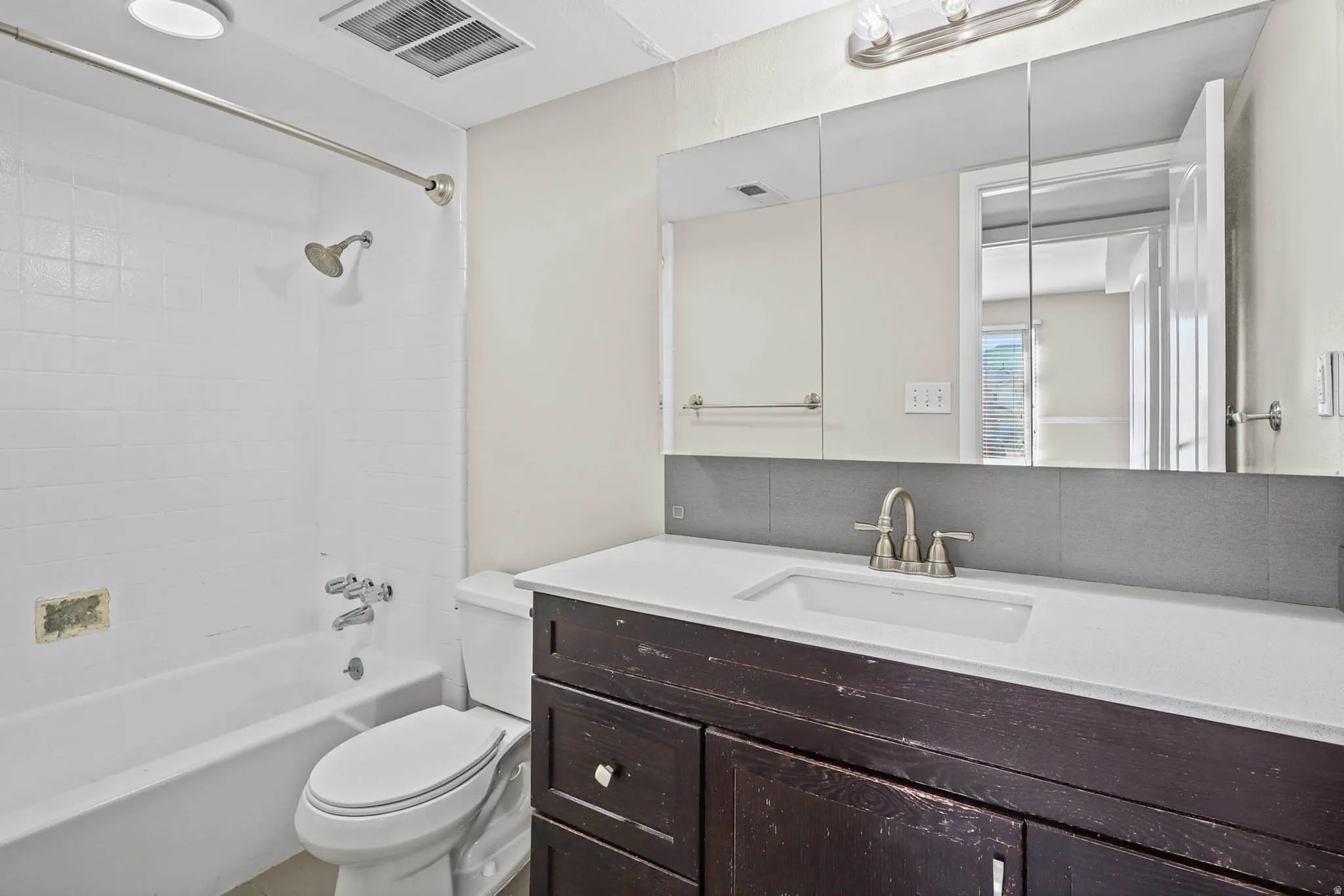 Full bath featuring vanity and shower / bath combination