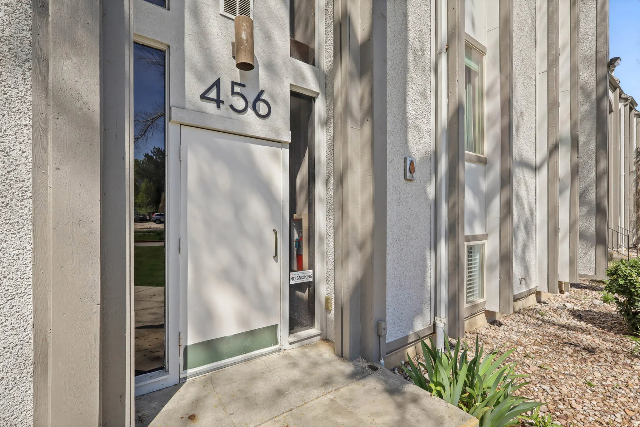 Property entrance featuring stucco siding