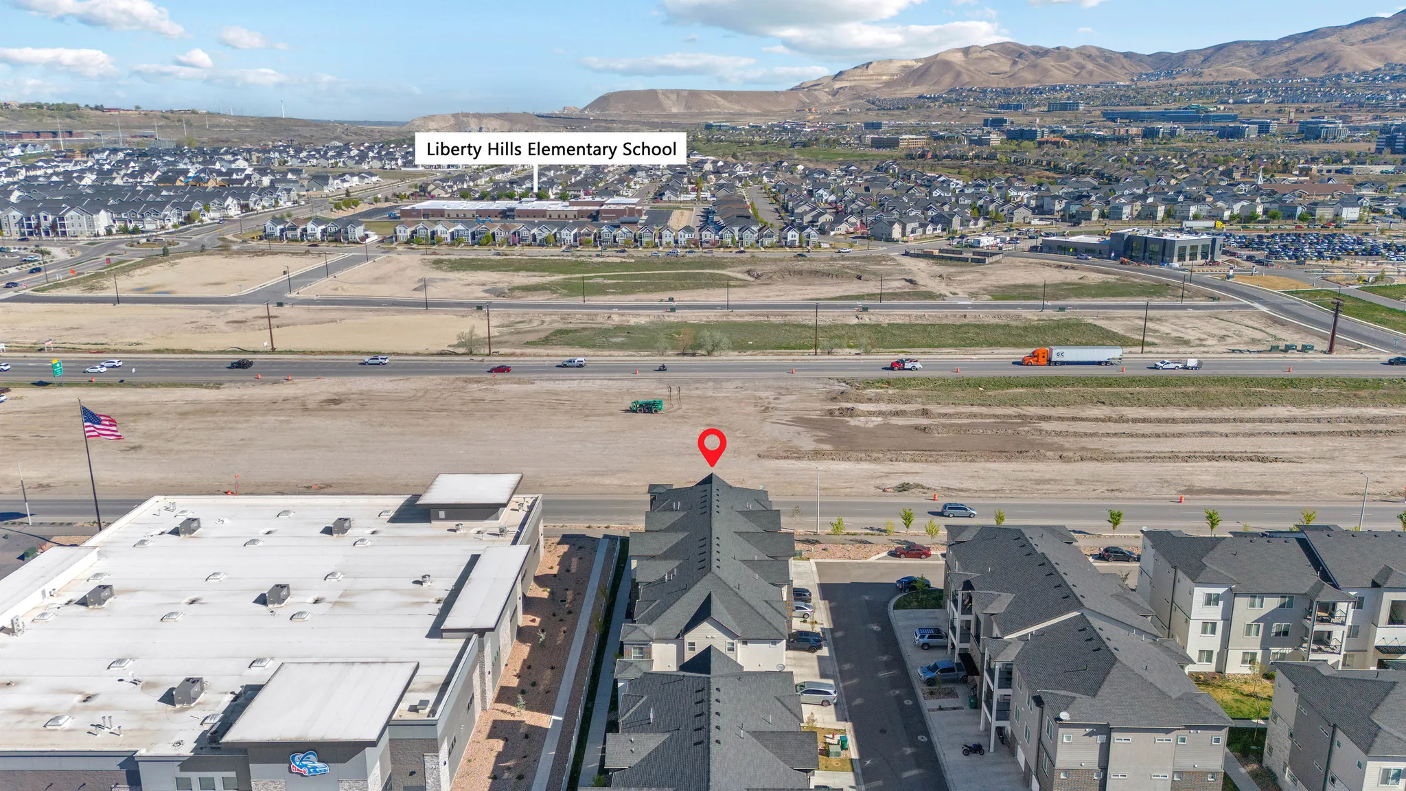 Aerial view of property's location with nearby suburban area and mountains