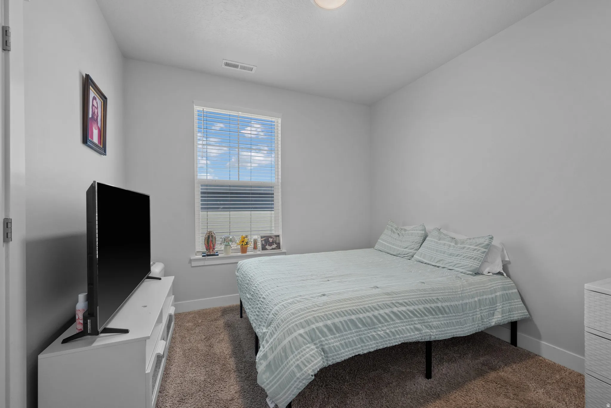 Carpeted bedroom featuring baseboards