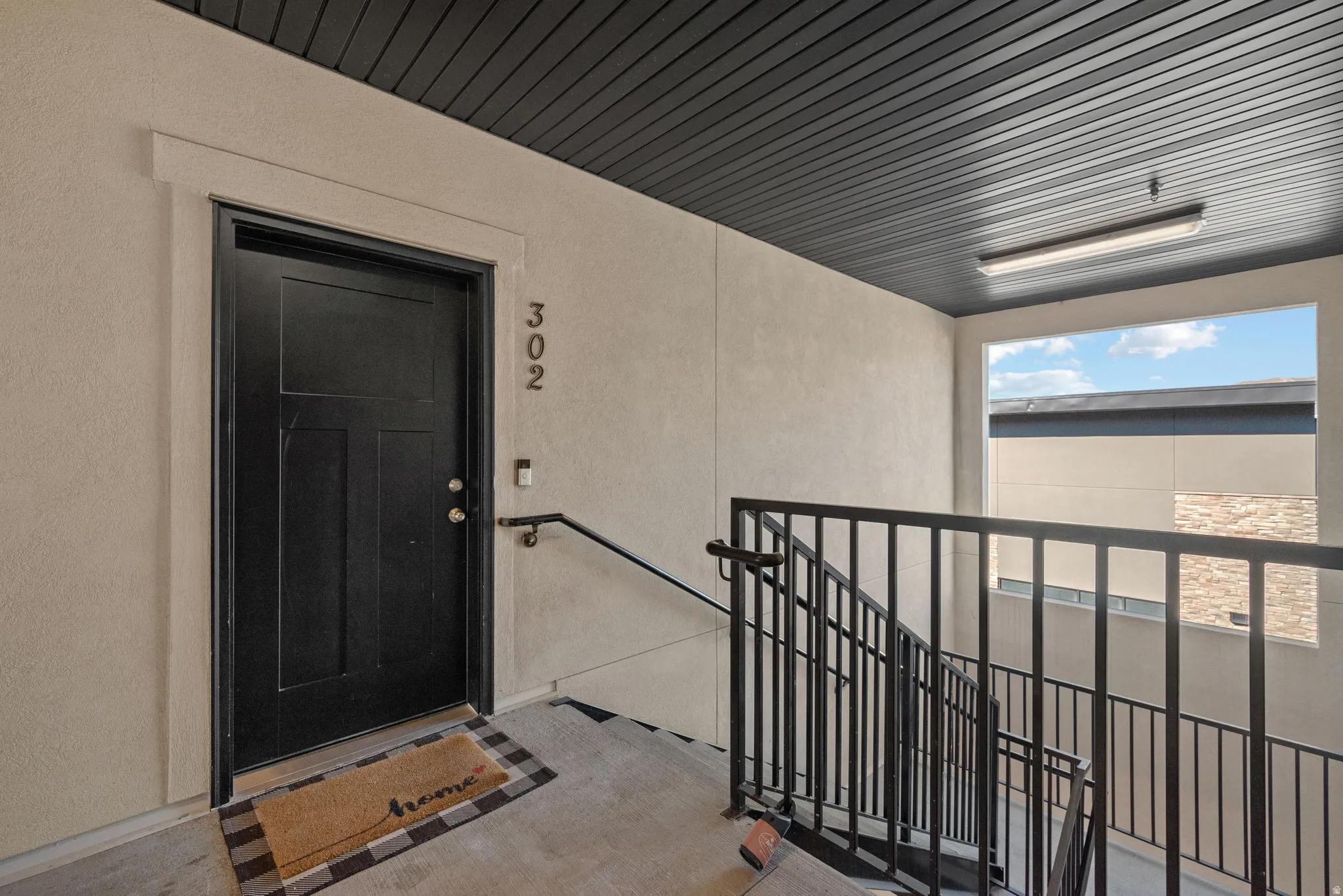 Doorway to property with stucco siding