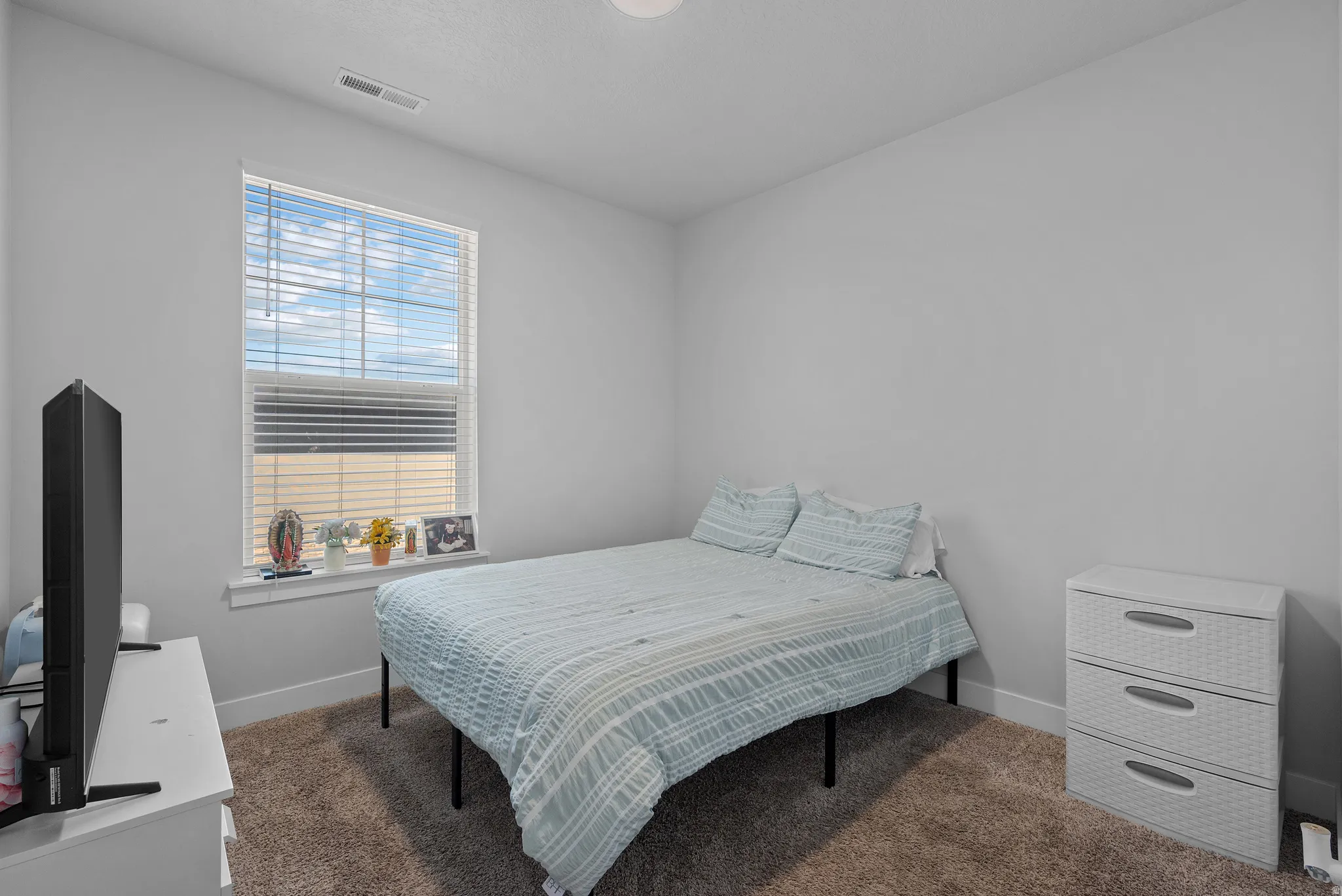 Bedroom with dark colored carpet
