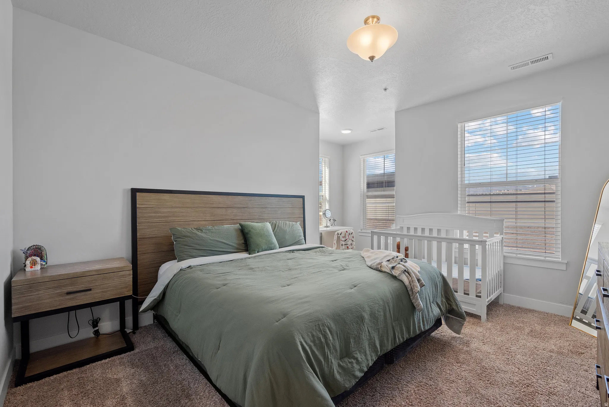 Bedroom with carpet floors and a textured ceiling