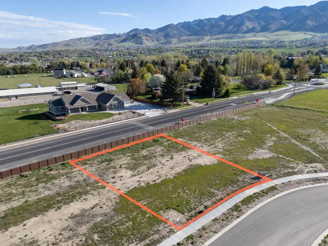 Aerial view of property and surrounding area featuring a mountain backdrop and property boundaries highlighted