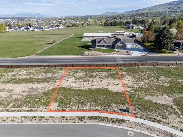 Aerial view of residential area with mountains and property parcel outlined