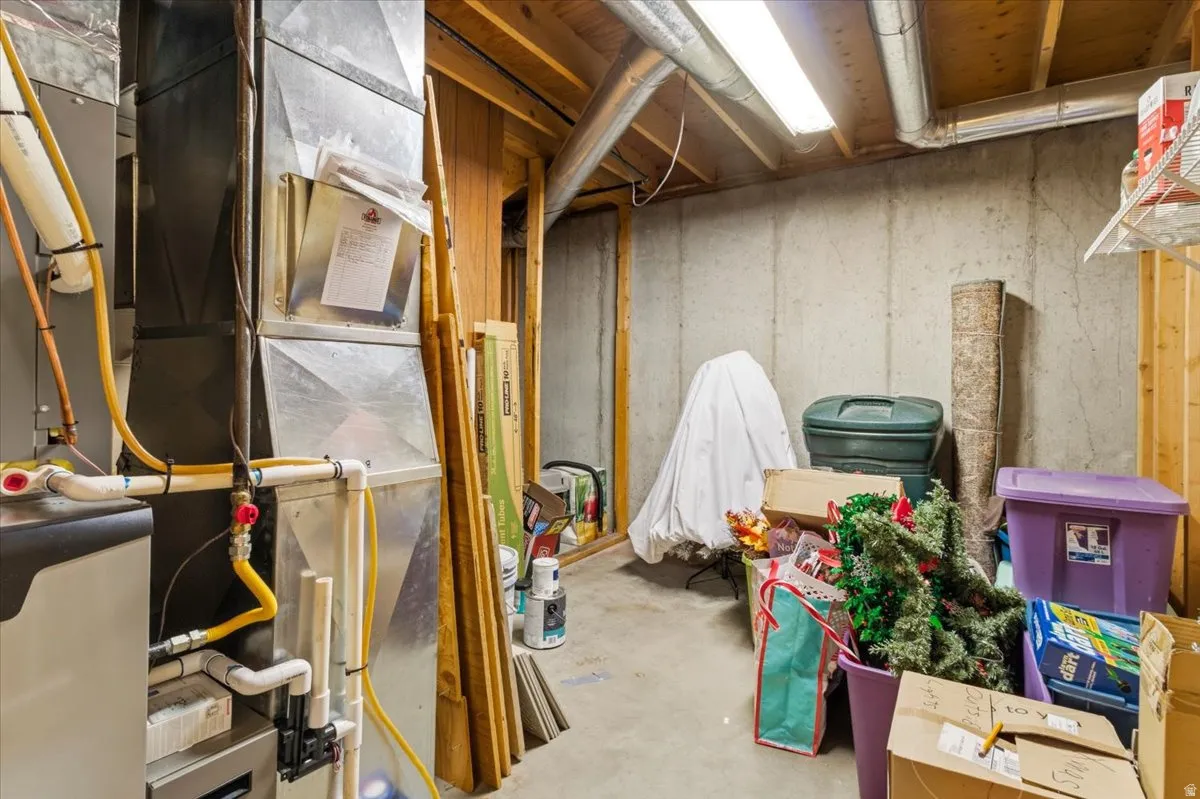 Unfinished basement featuring heating unit