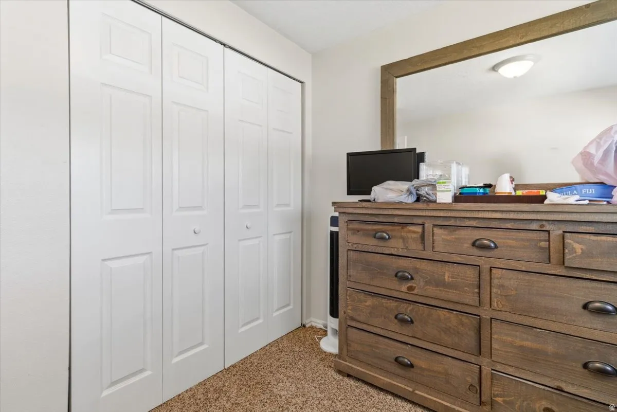 Bedroom featuring a closet and light colored carpet