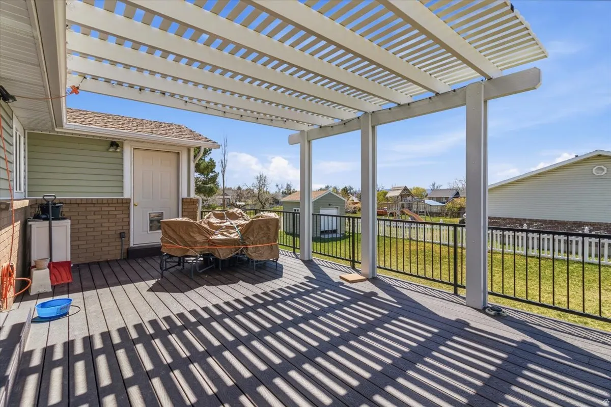 Deck featuring a residential view, a lawn, and outdoor dining space