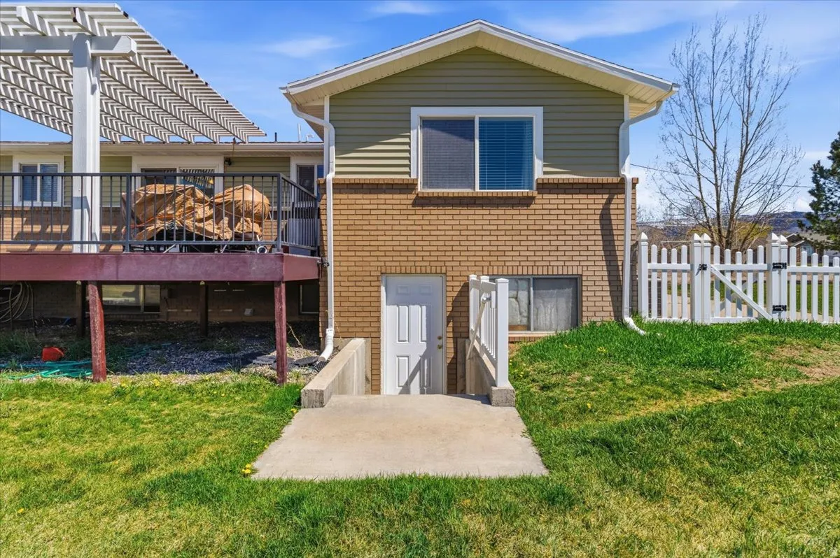 Back of property with brick siding and a deck