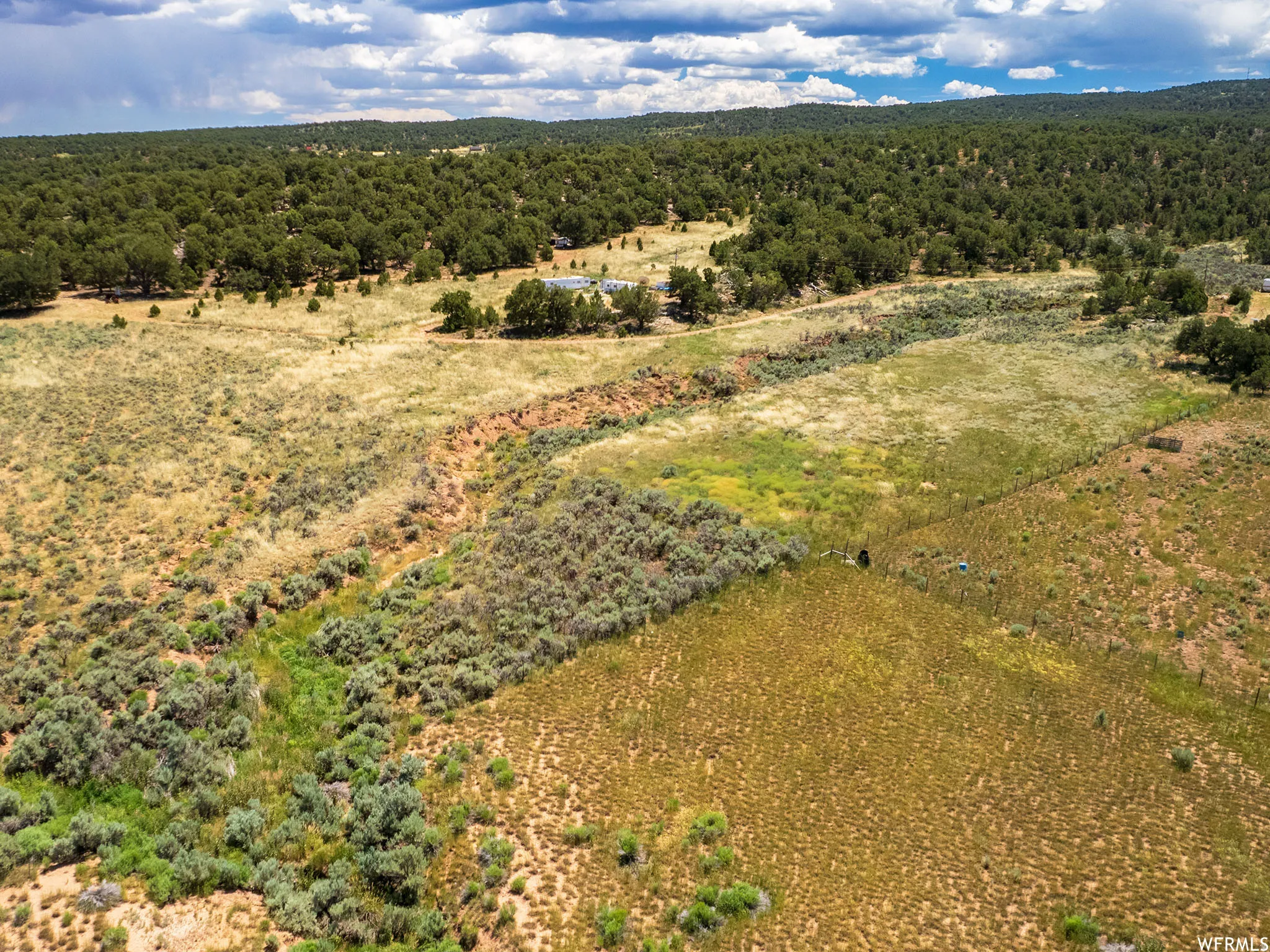 Aerial view of sparsely populated area featuring a heavily wooded area