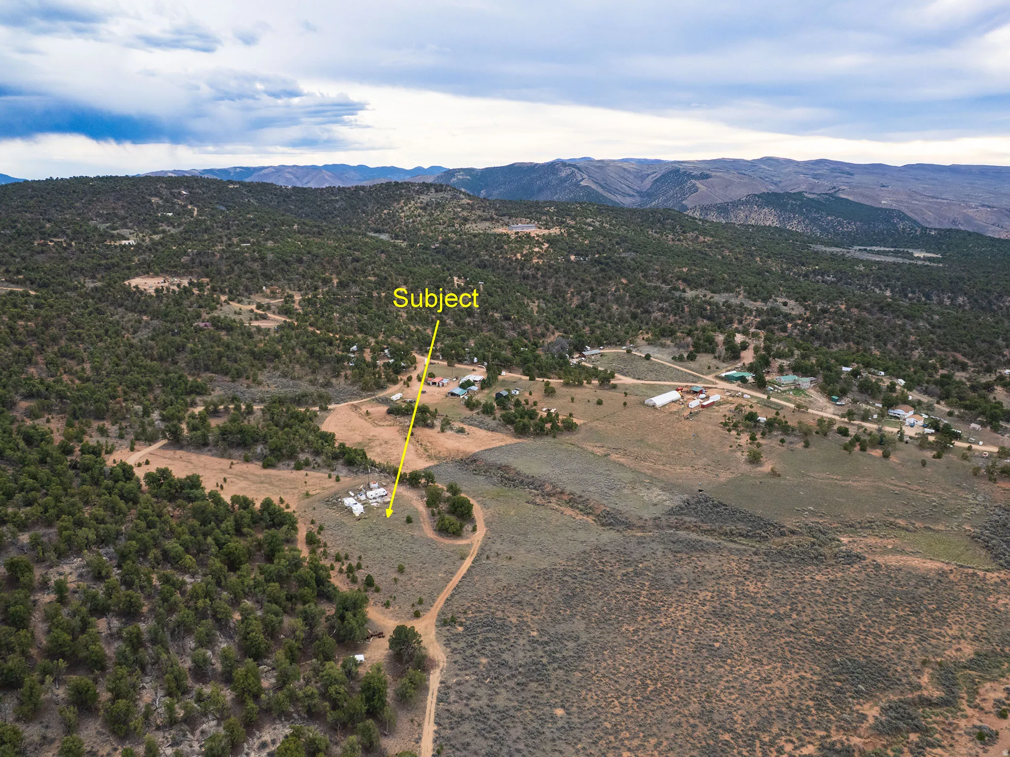 Overview of rural landscape featuring a mountain backdrop
