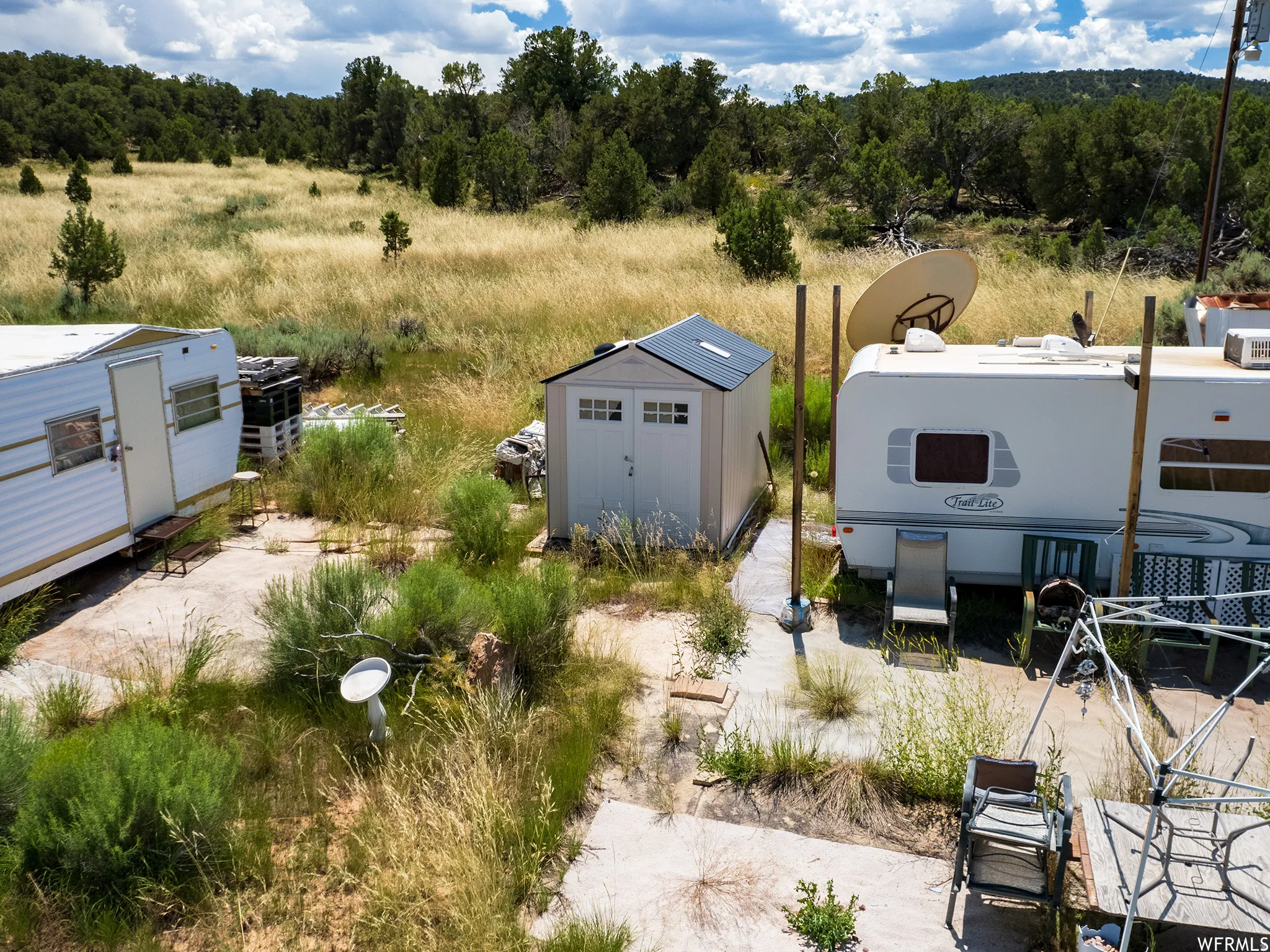 View of yard with a storage unit, a patio area, and a view of rural / pastoral area