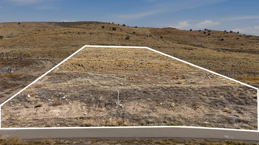Overview of rural landscape featuring property boundaries highlighted and mountains