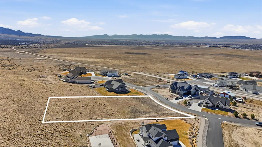 View of rural area featuring nearby suburban area and a mountain backdrop