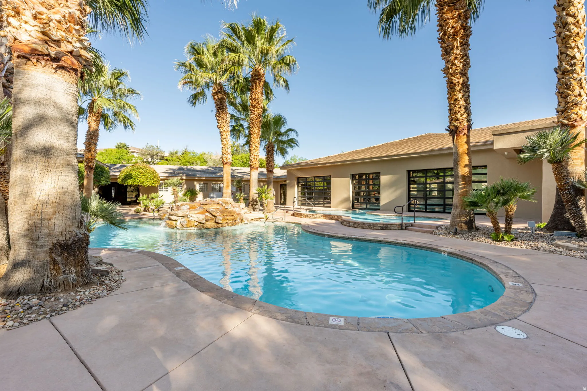 Community pool with a community hot tub and a patio area