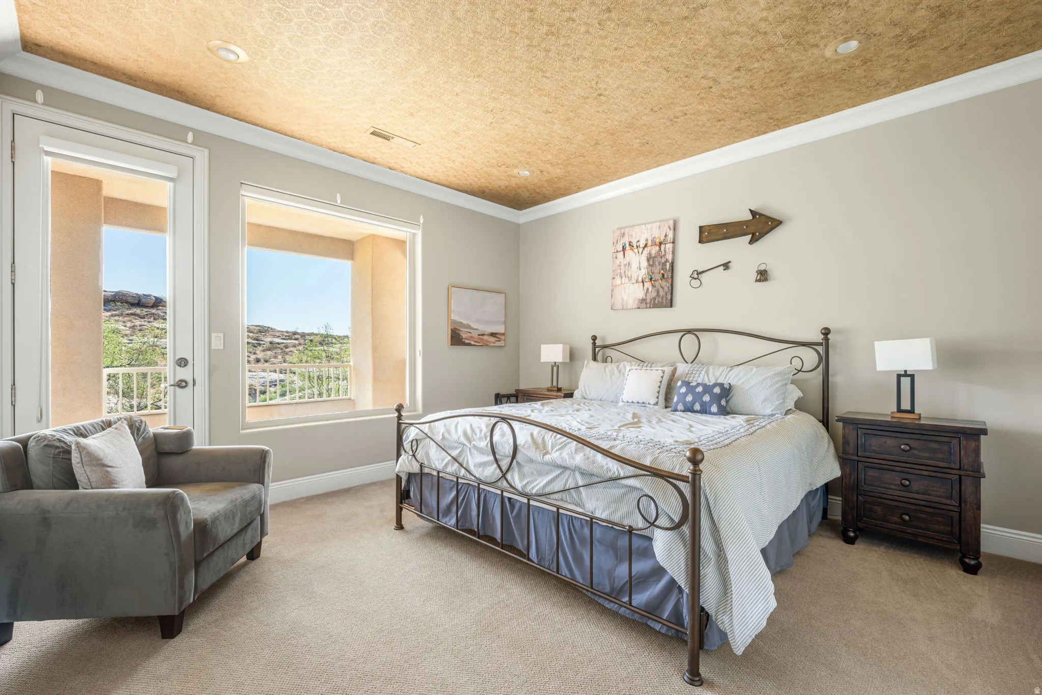 Carpeted bedroom with access to exterior and ornamental molding