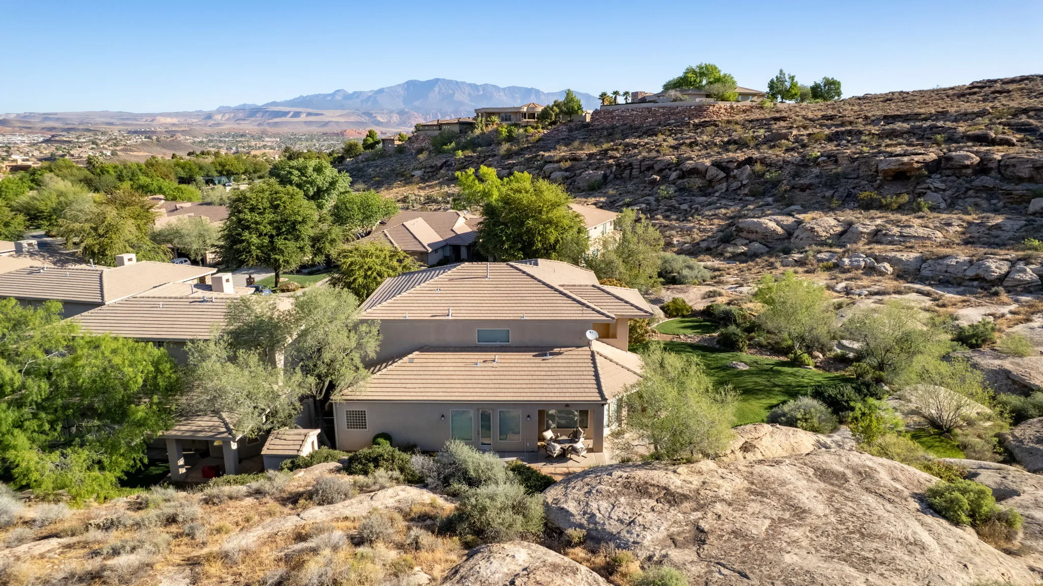 Aerial view of property and surrounding area featuring mountains