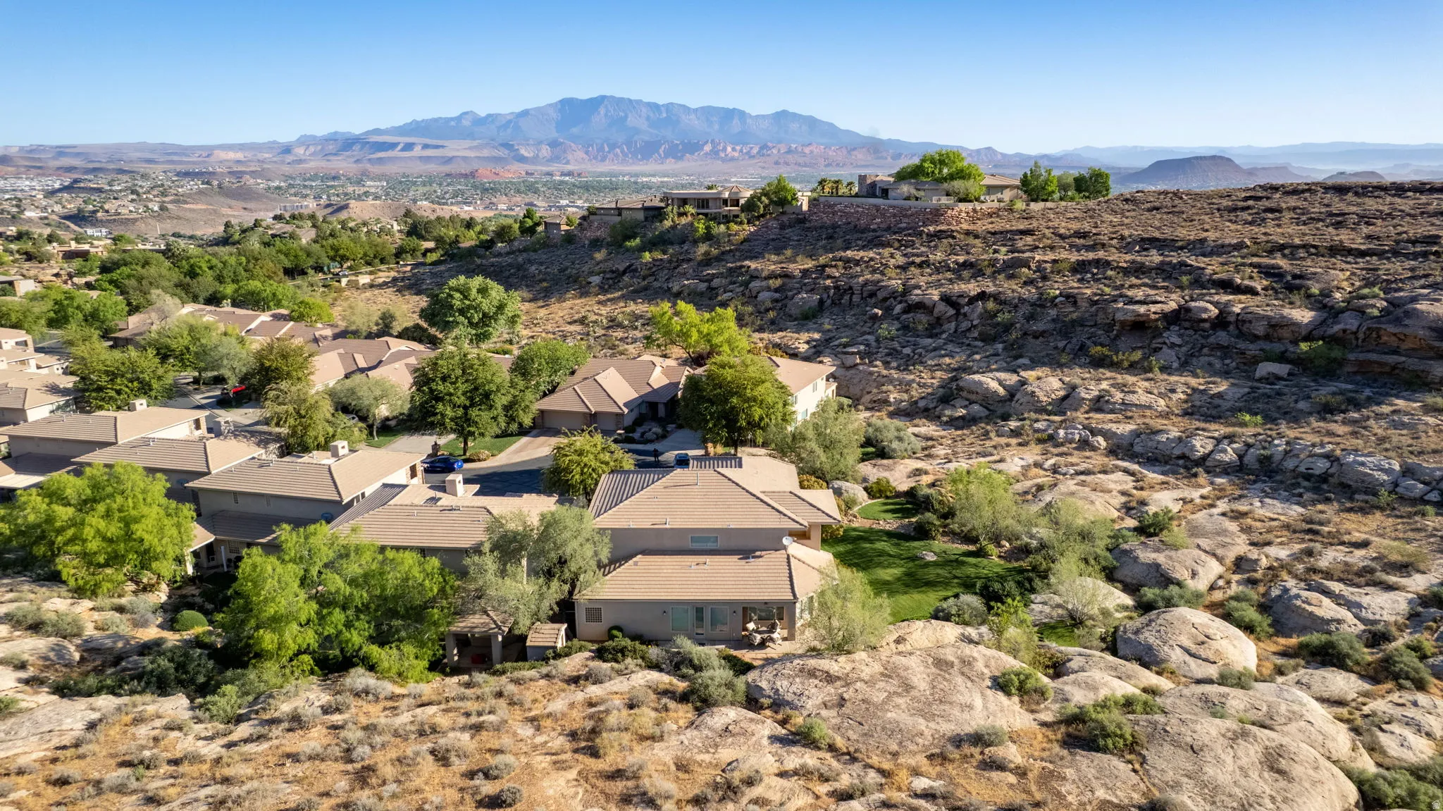 Aerial perspective of suburban area with a mountainous background