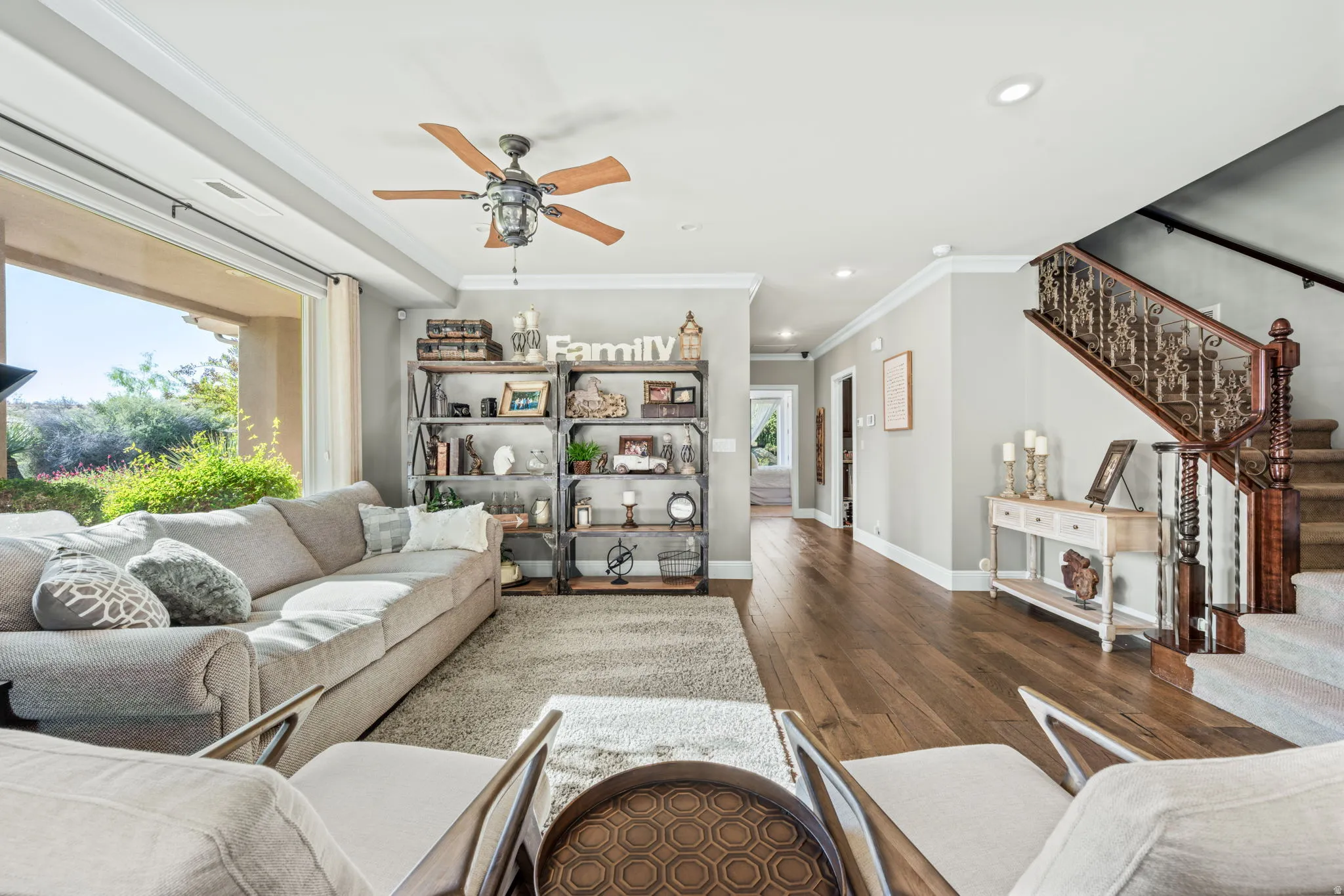 Living area with crown molding, dark wood-style flooring, ceiling fan, and recessed lighting