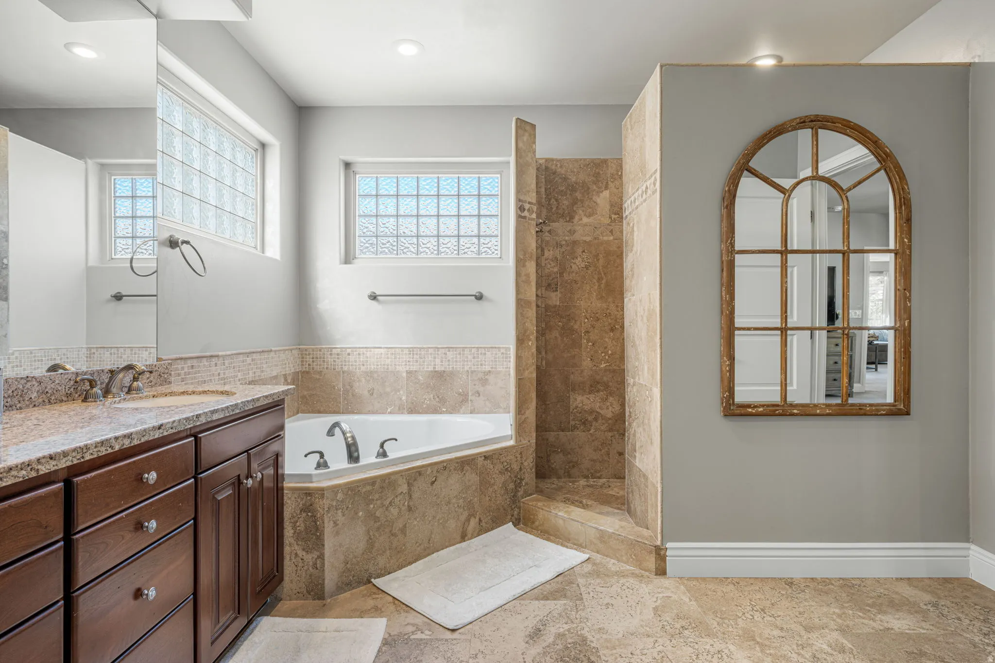 Full bathroom with a walk in shower, vanity, a bath, and recessed lighting