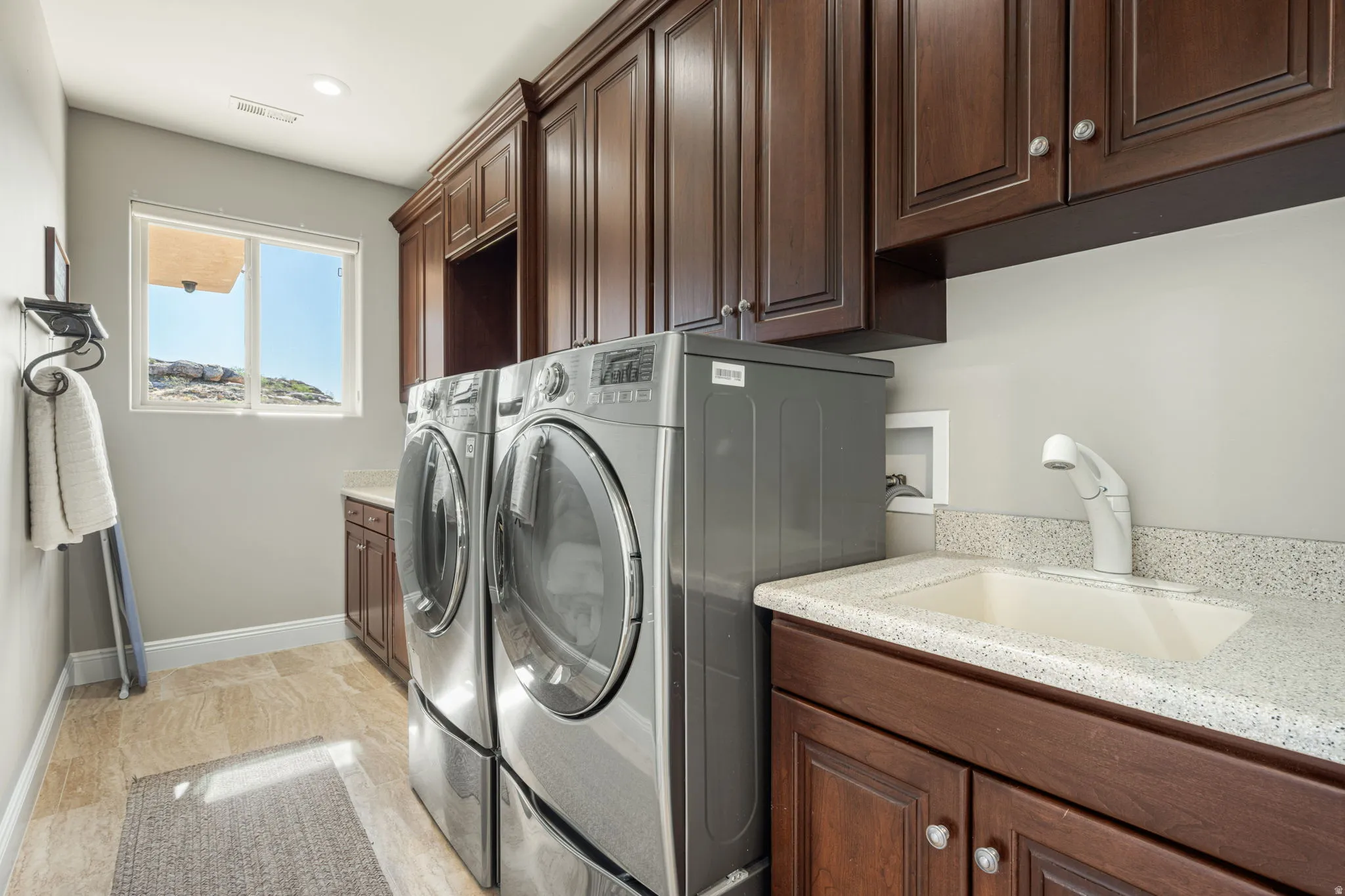 Laundry area featuring cabinet space, washing machine and dryer, and recessed lighting