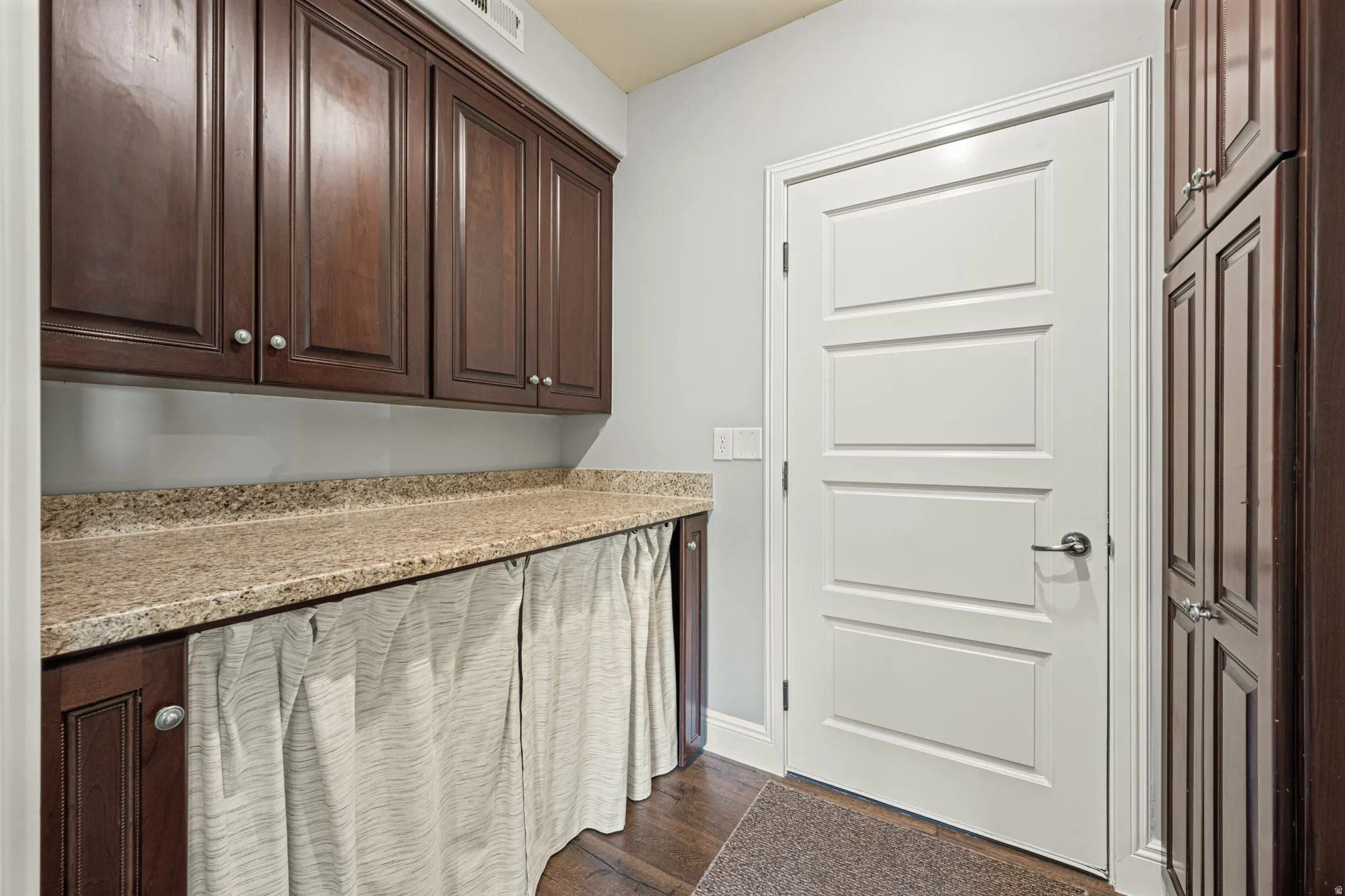 Laundry room featuring dark wood finished floors