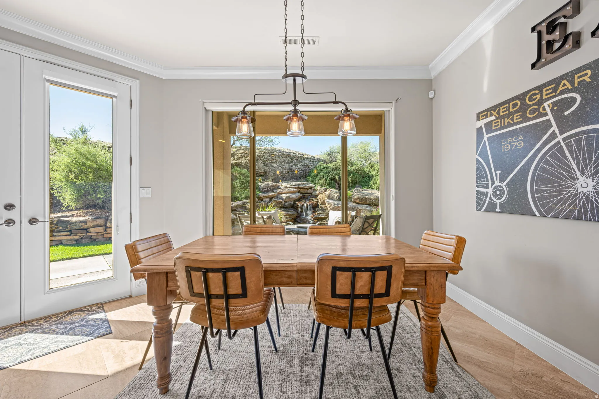 Dining area featuring ornamental molding, wood finished floors, and a chandelier