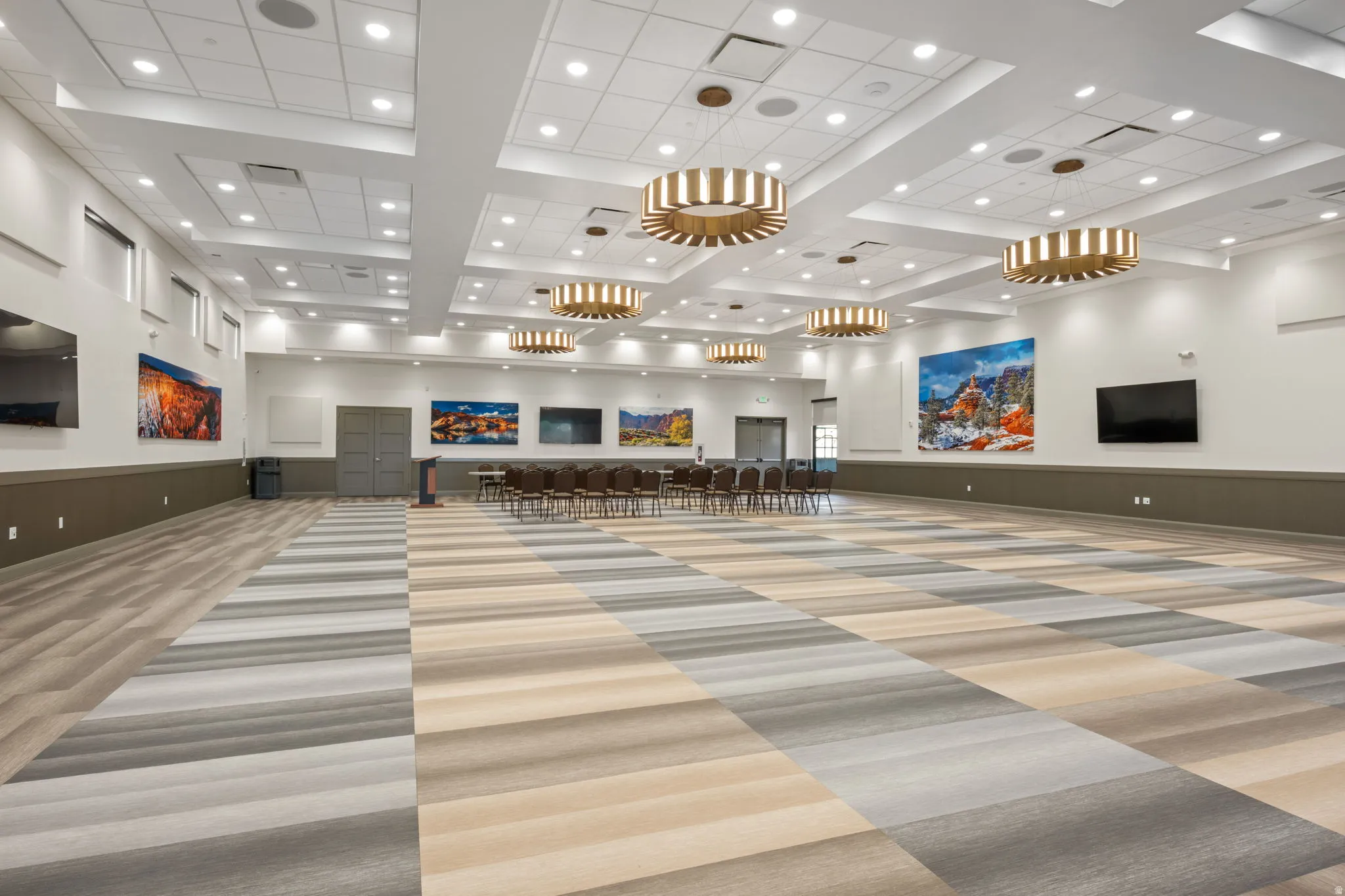 Building lobby featuring recessed lighting, a wainscoted wall, and high coffered ceiling