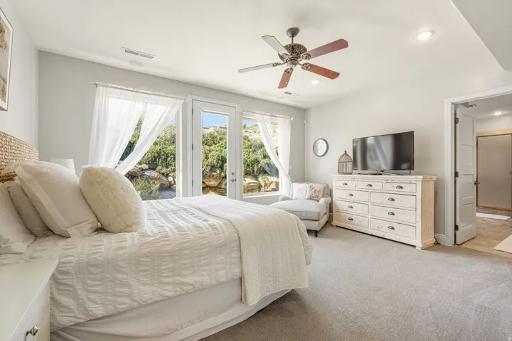 Bedroom with a ceiling fan, access to exterior, light colored carpet, and recessed lighting