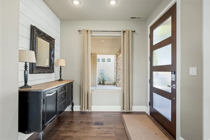 Entryway with hardwood / wood-style floors and recessed lighting