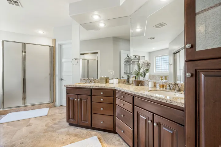 Bathroom featuring double vanity, a stall shower, and recessed lighting
