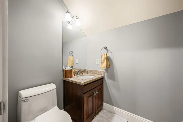 Half bathroom featuring vanity and toilet