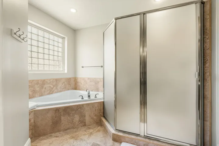 Full bath featuring a shower stall, a bath, and recessed lighting