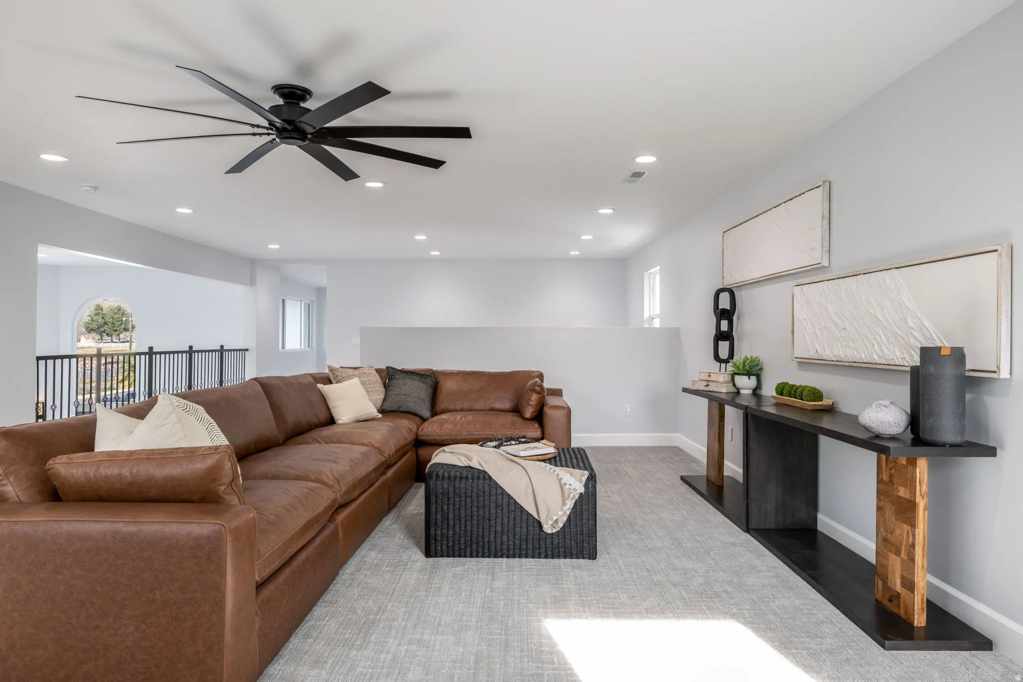 Living room with a ceiling fan and recessed lighting