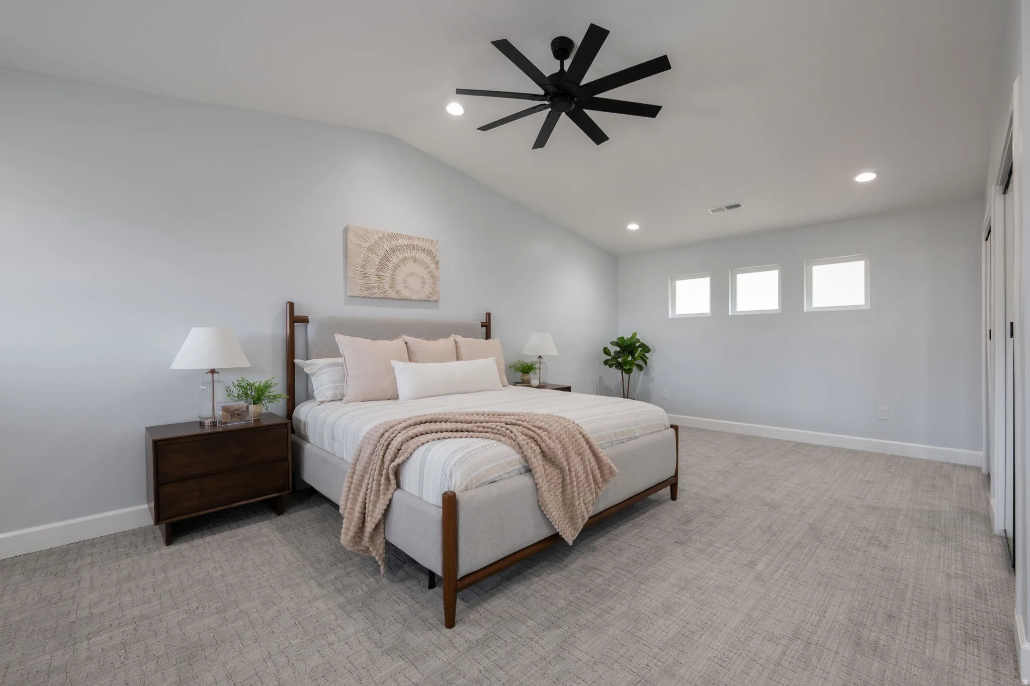 Bedroom with light carpet, ceiling fan, recessed lighting, and lofted ceiling