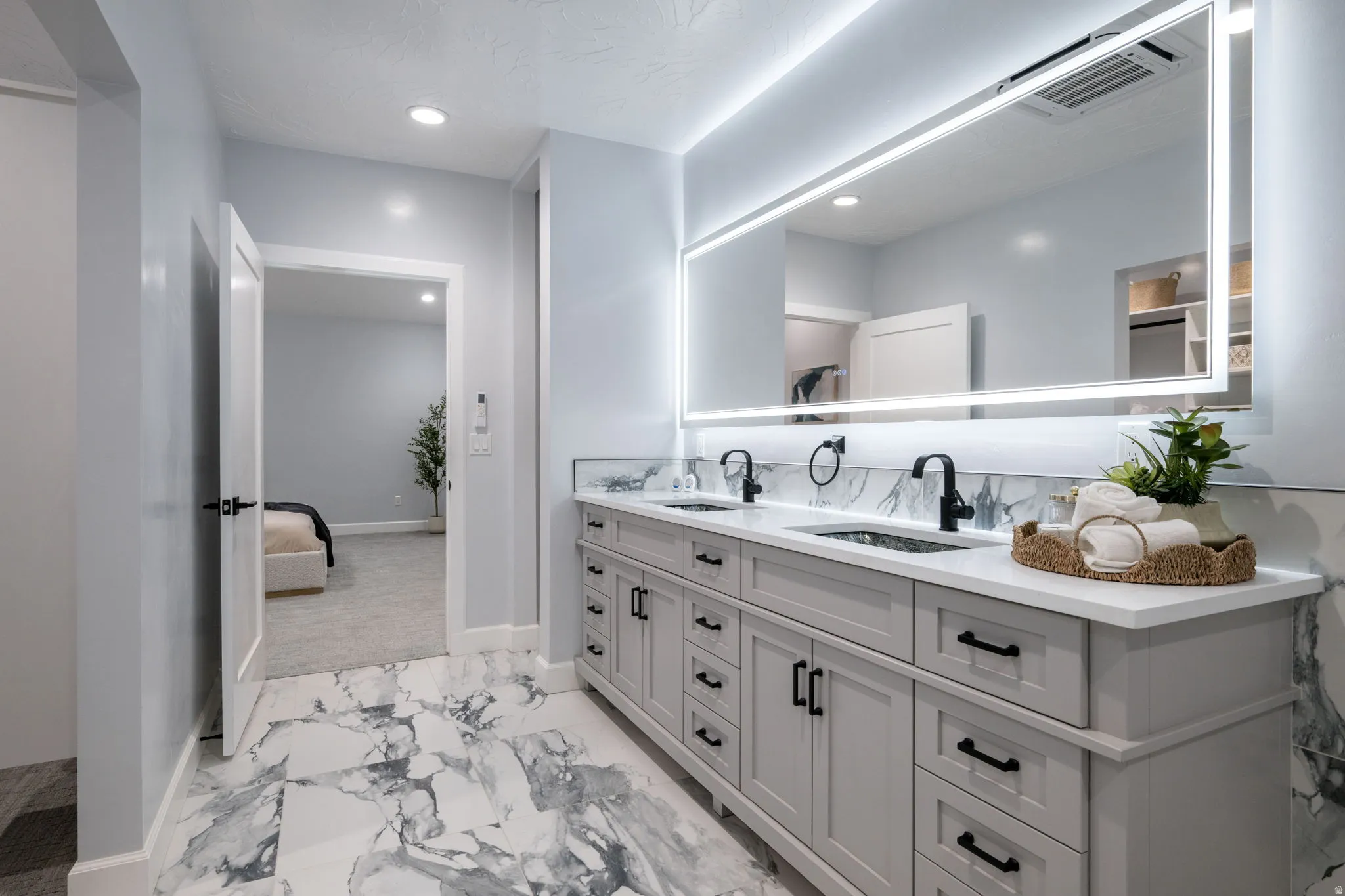 Full bath featuring double vanity, ensuite bath, light marble finish flooring, and recessed lighting