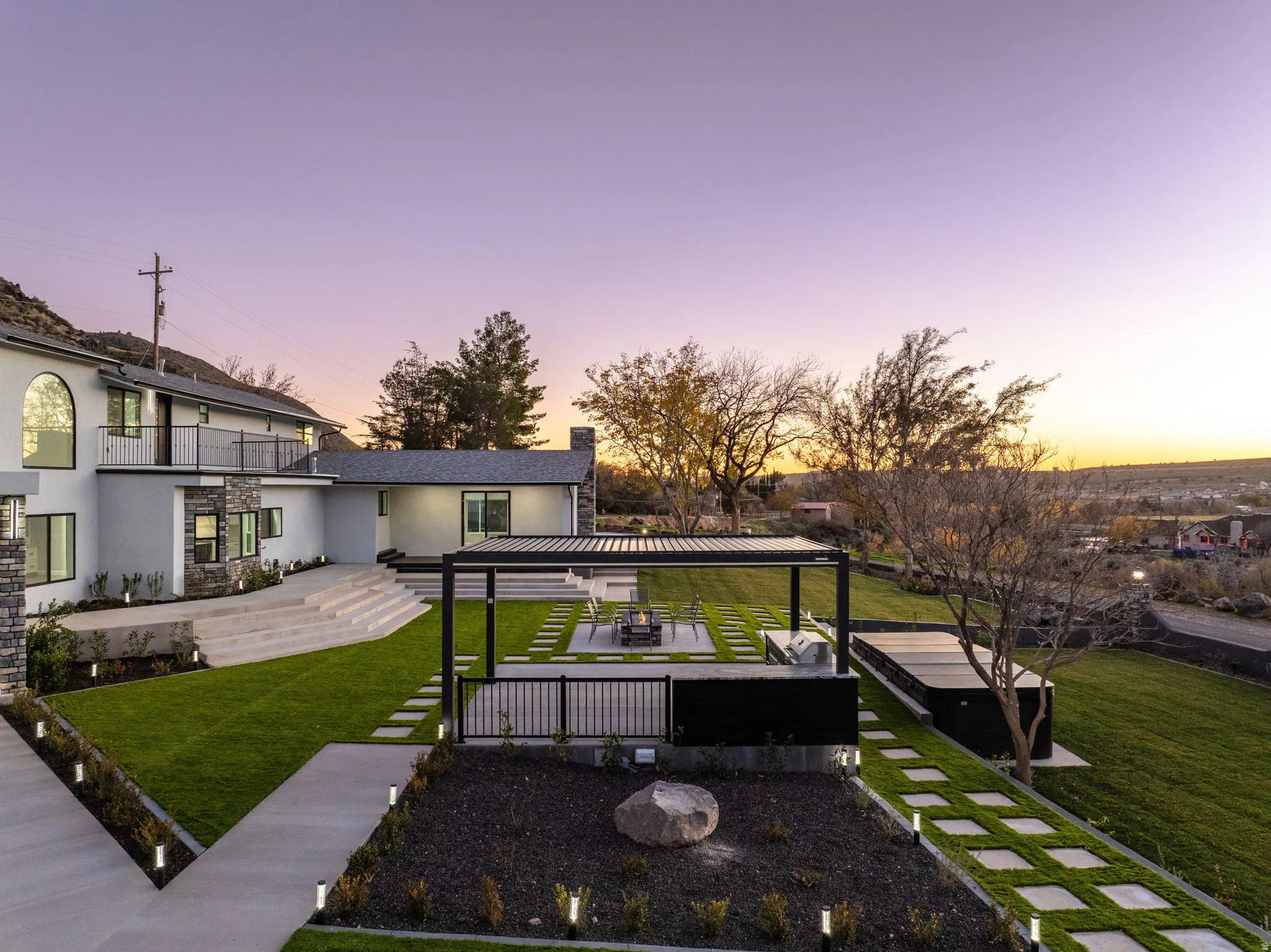 View of grassy yard featuring a patio area