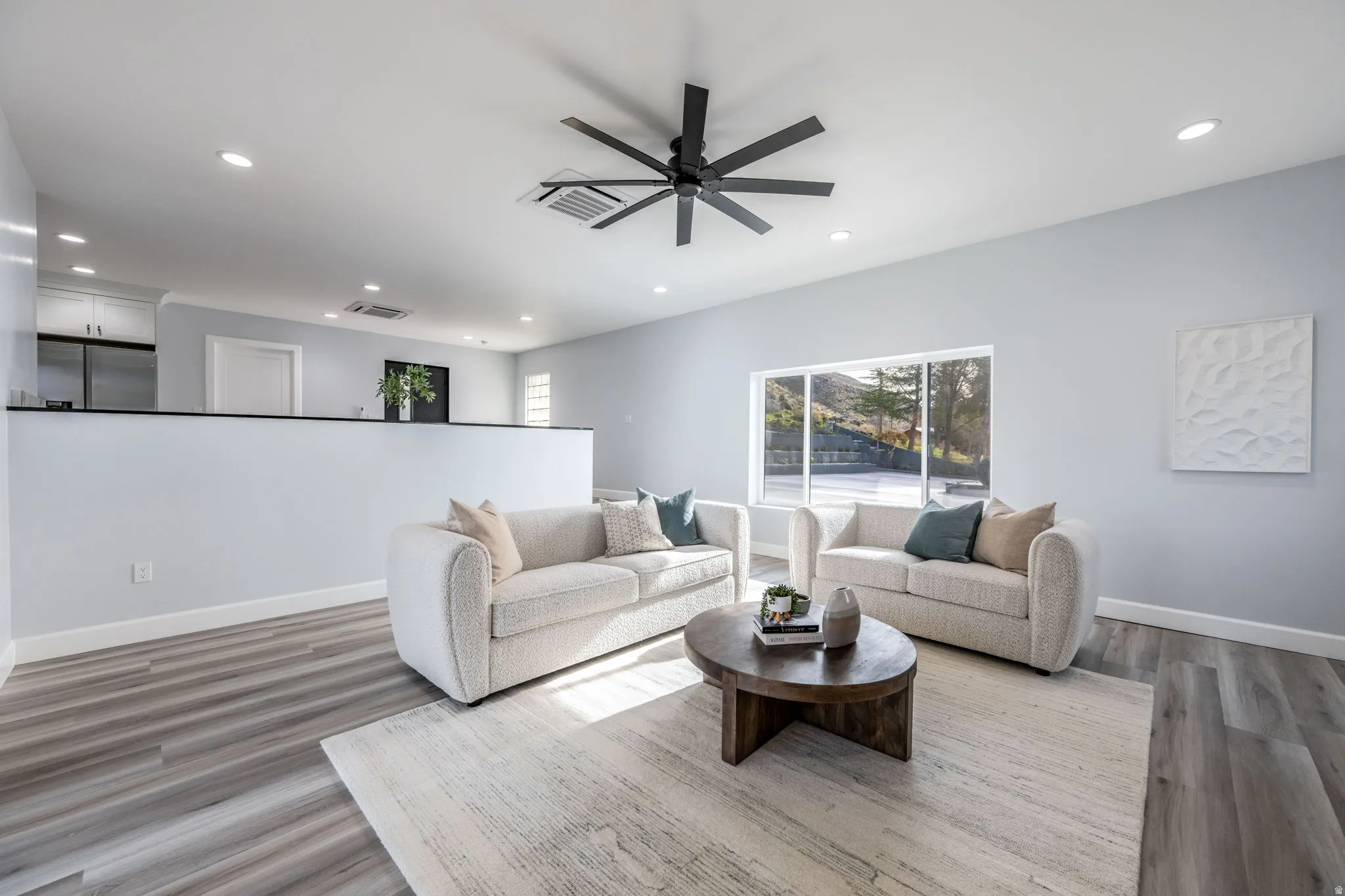 Living area featuring recessed lighting, ceiling fan, and light wood-style flooring