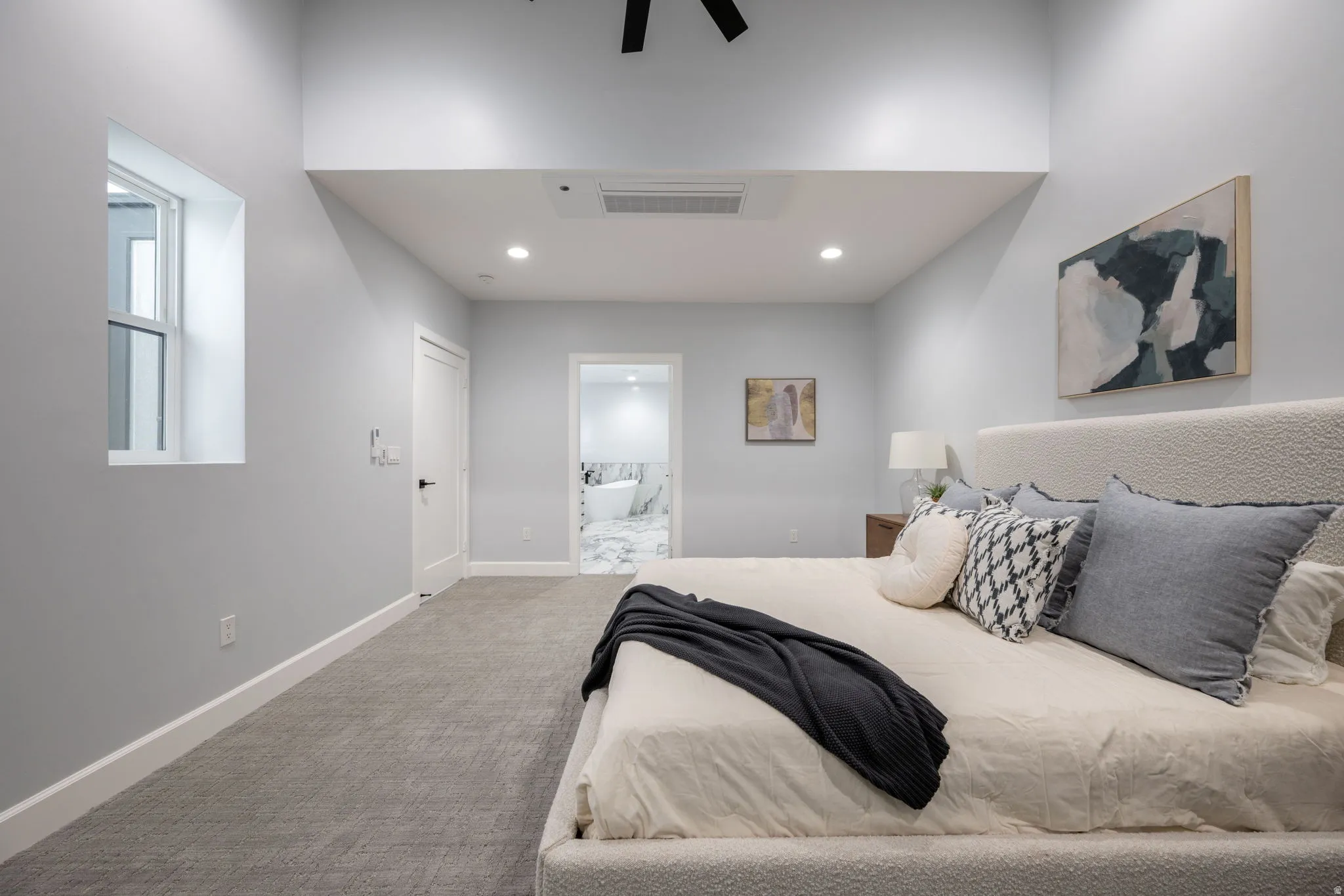 Bedroom featuring light carpet, ensuite bath, a ceiling fan, and recessed lighting