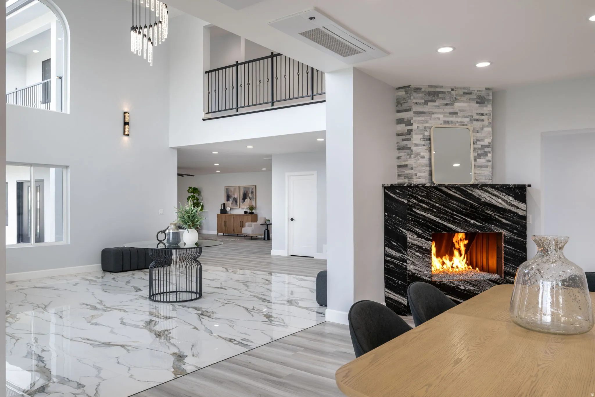 Living room with recessed lighting and a warm lit fireplace