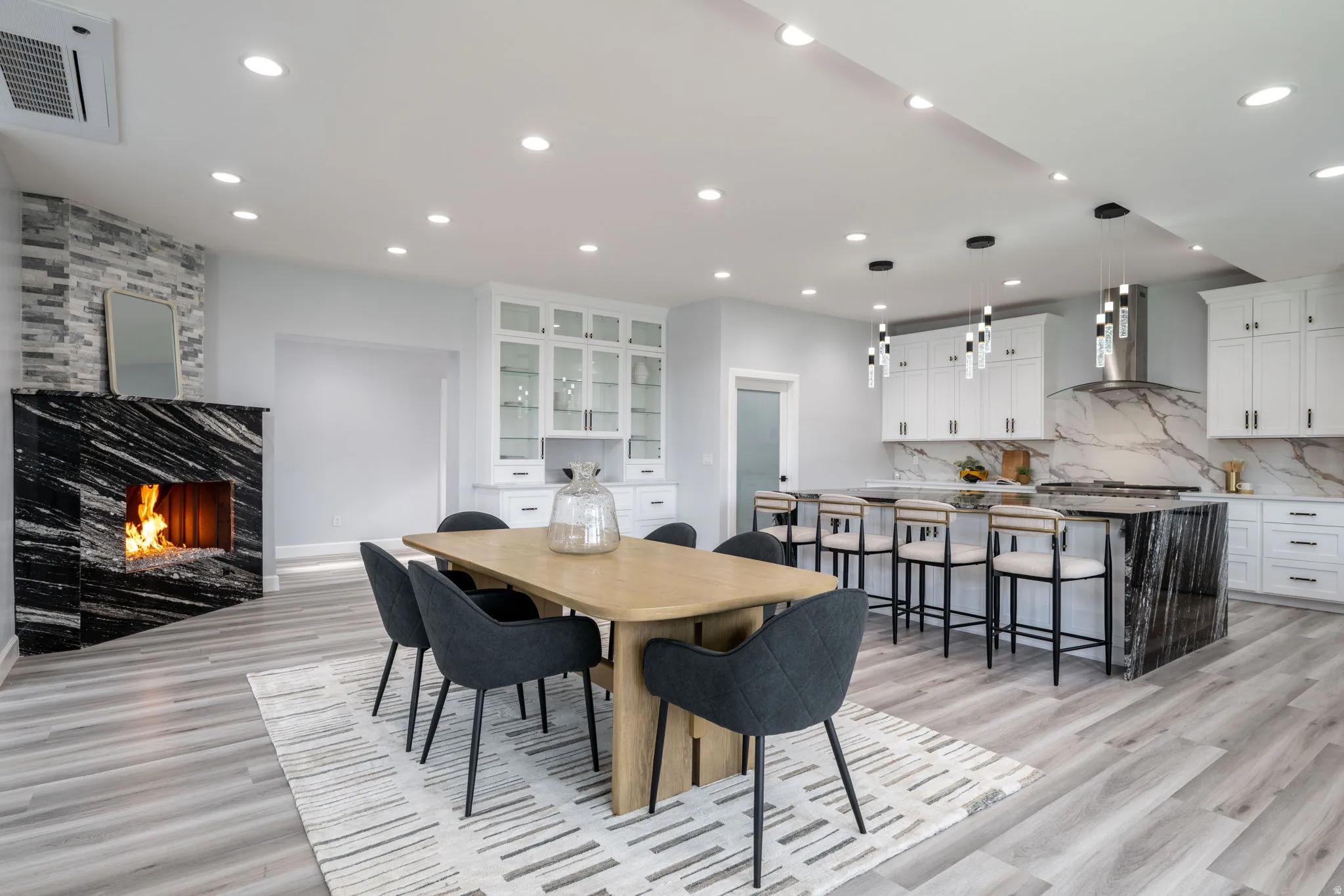 Dining area featuring a fireplace, recessed lighting, and light wood-type flooring