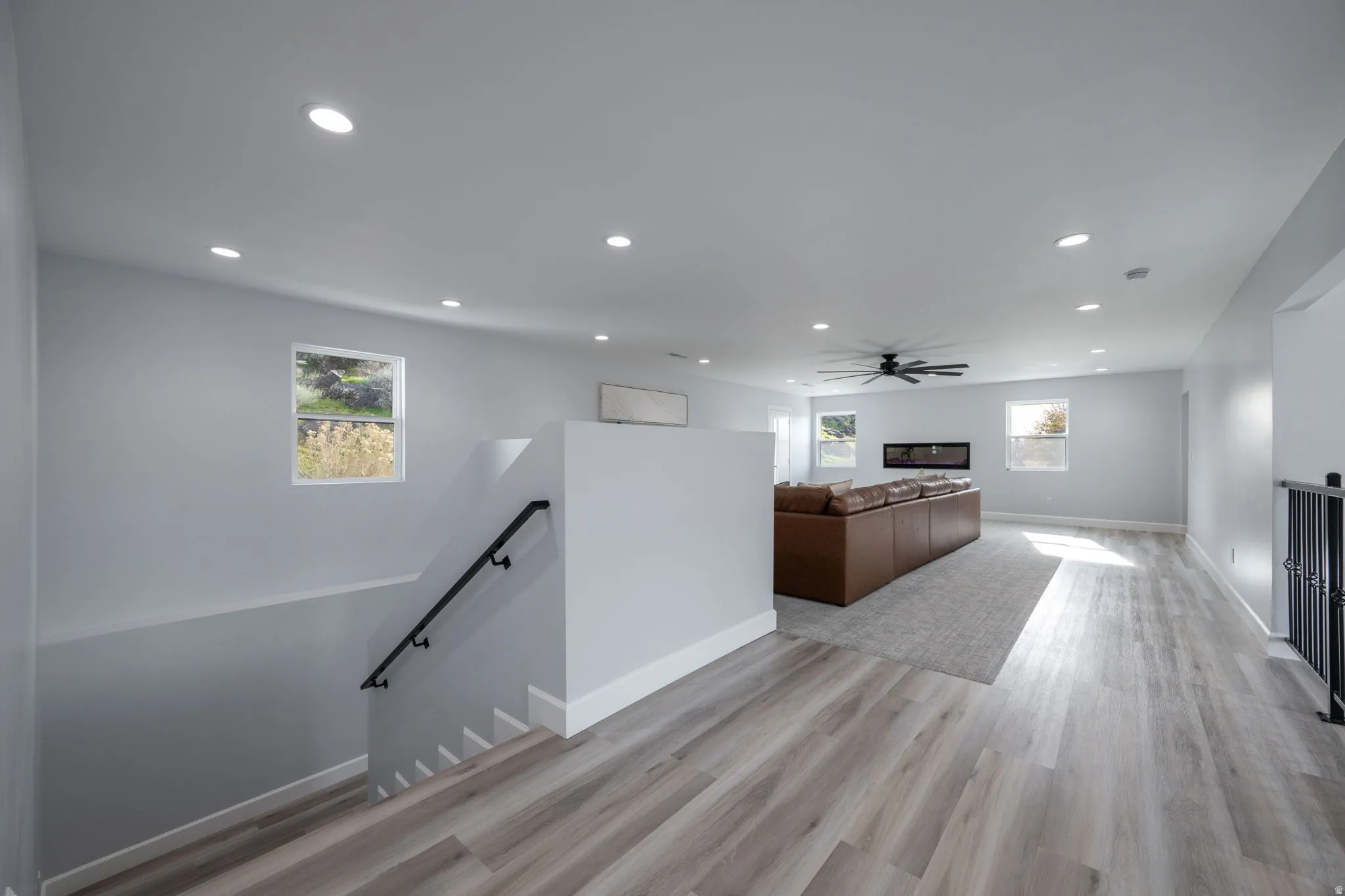 Unfurnished living room with light wood-style flooring, recessed lighting, and a ceiling fan