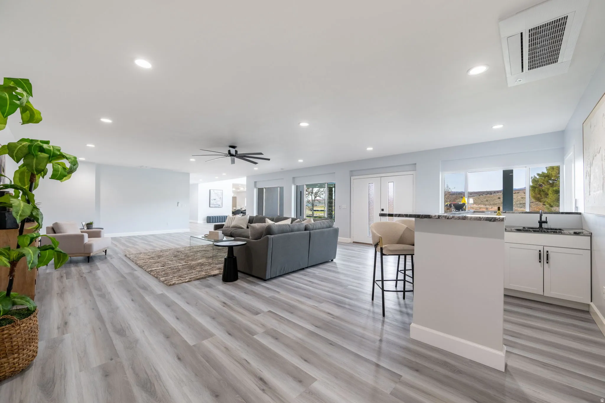 Living room featuring recessed lighting, a ceiling fan, and light wood-type flooring