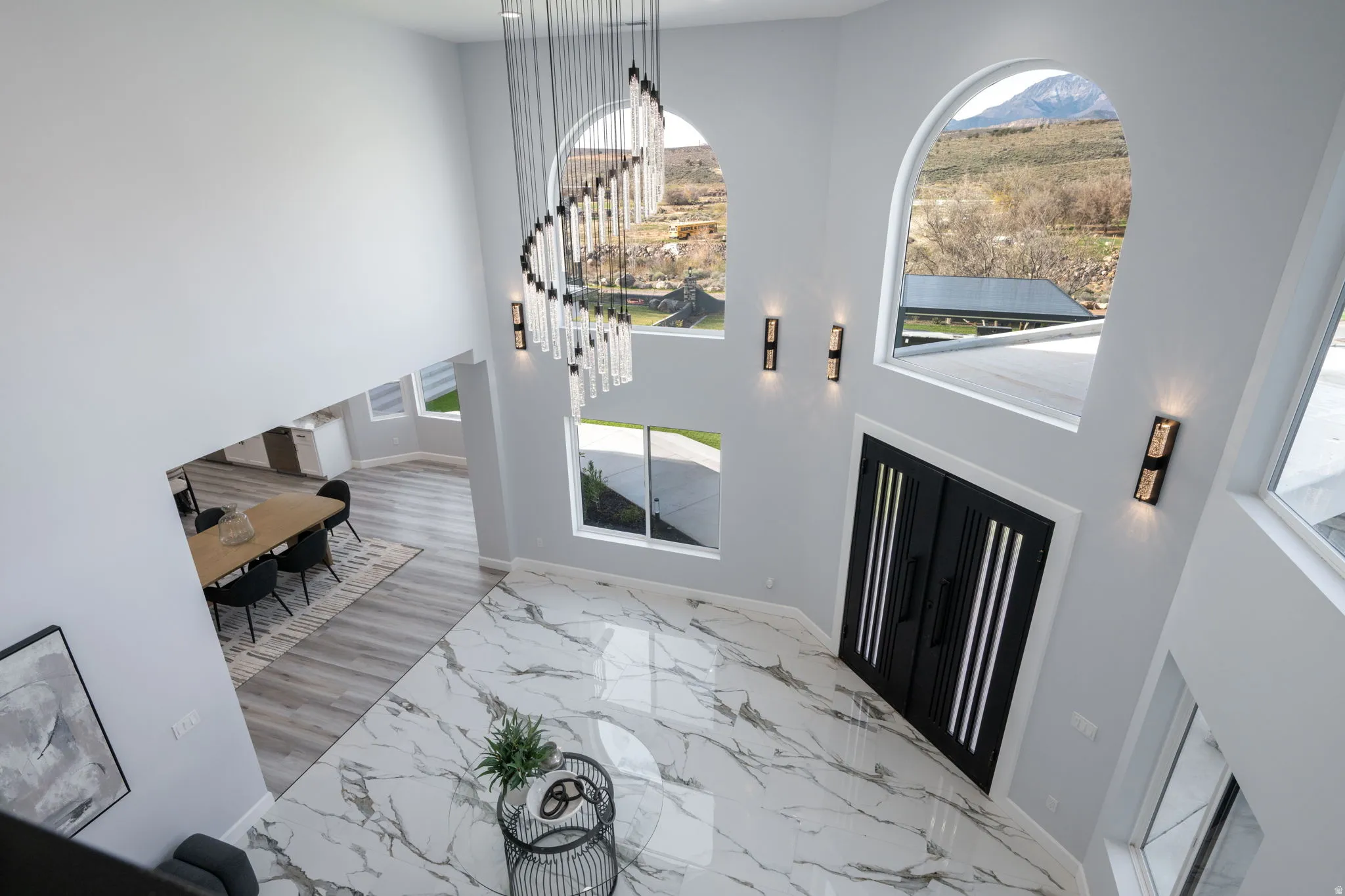 Entryway with a high ceiling and light marble finish flooring