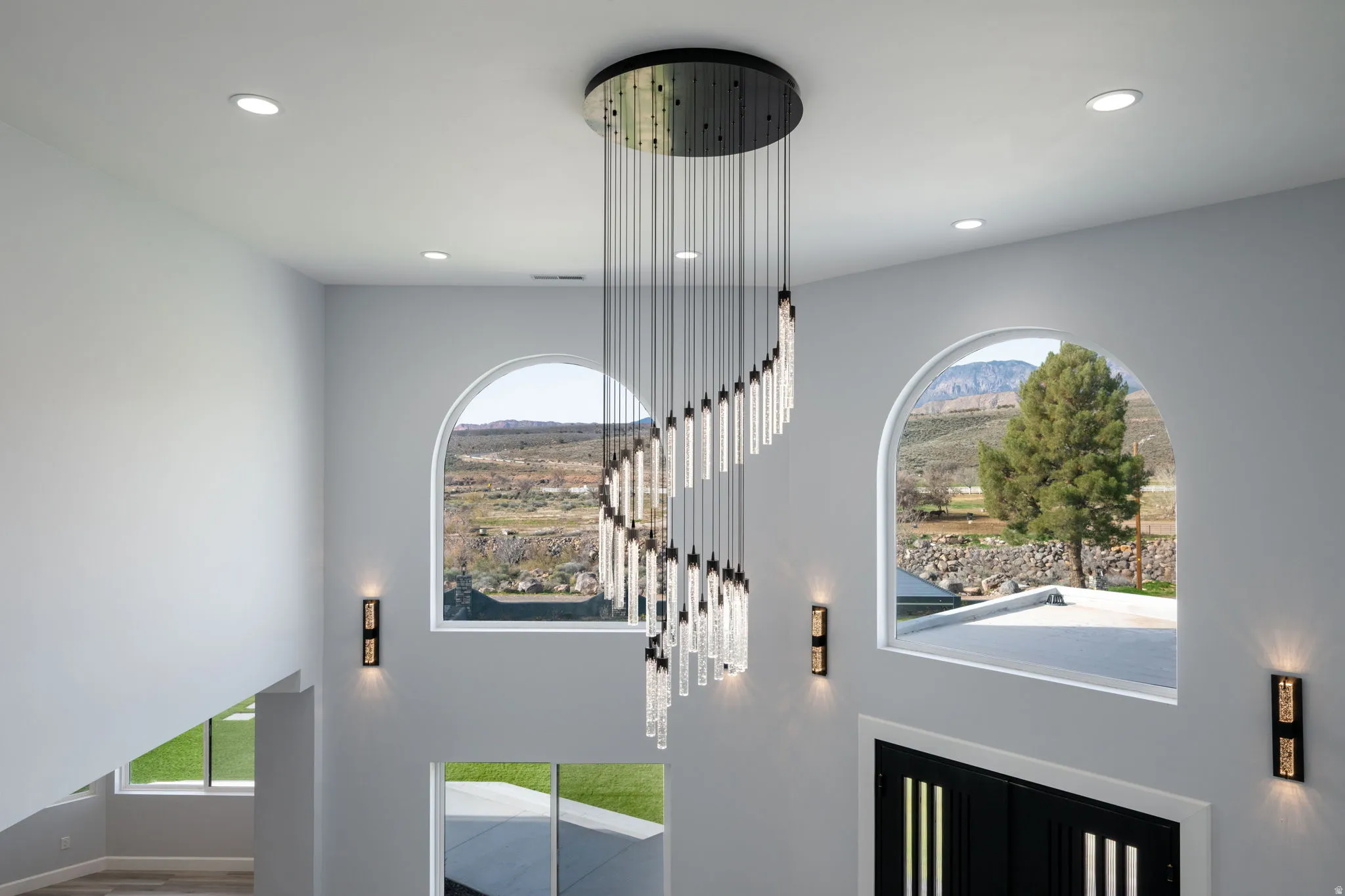 Foyer entrance featuring plenty of natural light, a high ceiling, a mountain view, and recessed lighting