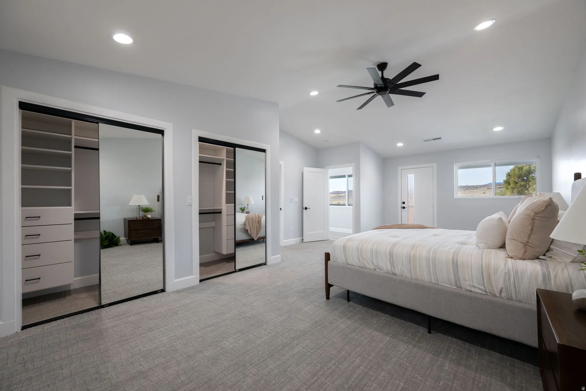 Bedroom with multiple closets, recessed lighting, lofted ceiling, ceiling fan, and light carpet
